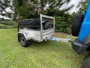 Right front view of a Blaze Nano trailer attached to a suzuki jimny. Lightweight aluminium trailer for easy towing