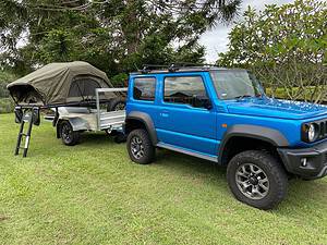 Suzuki Jimny hitched to a Blaze nano Trailer with the roof top tent folded out